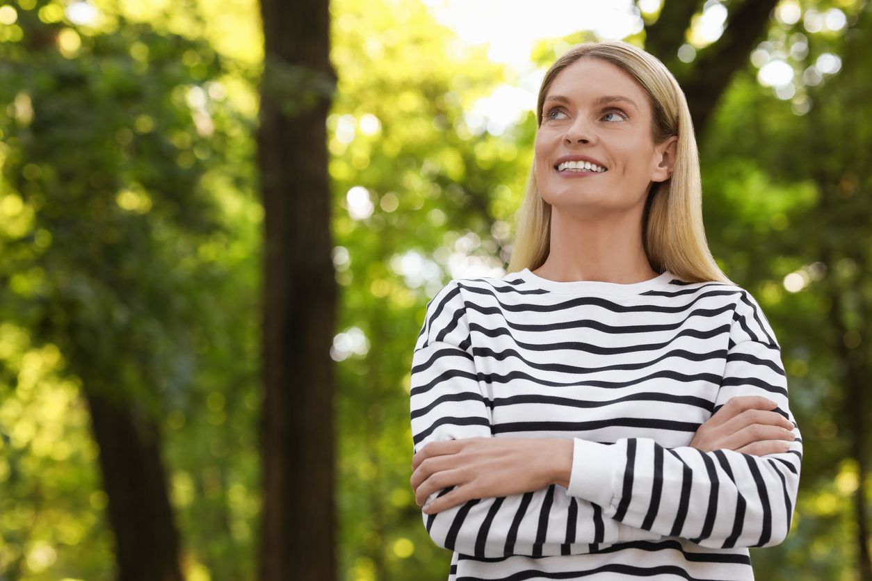 Portrait of happy woman in casual clothes outdoors.