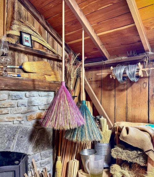 Colorful brooms hanging in Sadie Ford Farm.