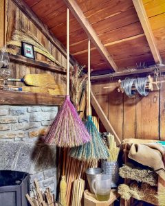 Colorful brooms hanging in Sadie Ford Farm.